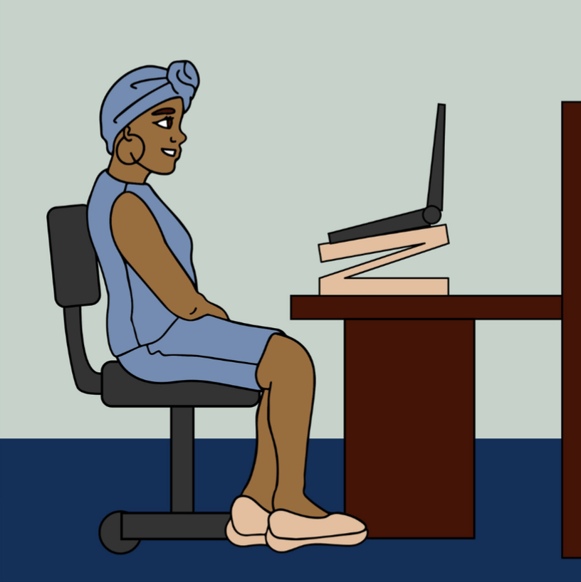 A women wearing a headwrap sitting at a desk. Her laptop is on a riser on the desk in front of her